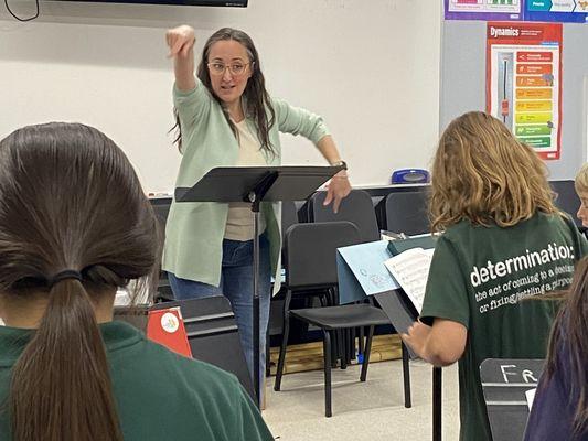 Mrs. H conducting singers in a rehearsal