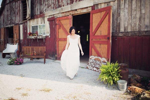 Bride exits the Wedding Barn at the Civil War Ranch in Carthage, MO.