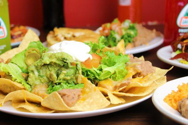 Our delicious supreme nachos topped with guacamole and sour cream.