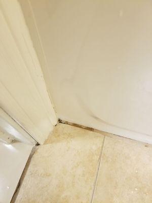 Bathroom floor next to bathtub.