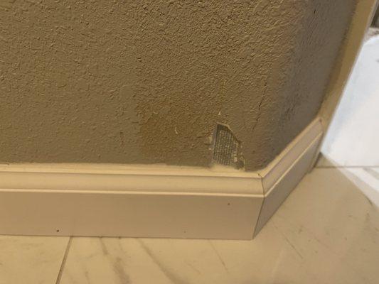 Gouge and wall that occurred when they removed previous baseboard.