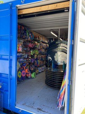 Beach goodies in a fun bright blue shipping container