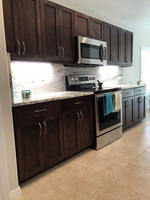 Real wood cabinets. Fabricated in locally in house. The doors are solid maple, they wear a Nottingham stain with a satin Lacquer finish.