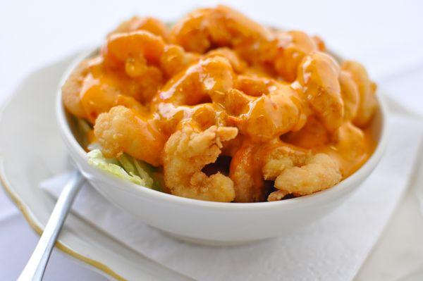 A bowl full of lettuce covered with plenty of our delicious fried shrimp, then it's drizzled with our creamy, spicy "Boom Boom Sauce"