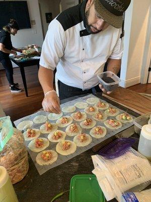 Ahi Tuna Poke wrapped with a wasabi pickled daikon with avocado mousse, black sesame and Kasami Nori