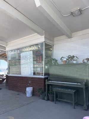 The walk up ordering station with piano and list of milkshake flavors