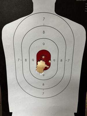 Shooting target with a hole in the center area