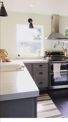 Our kitchen is complete with our enamel cast iron sink and all beautiful pot-filler.