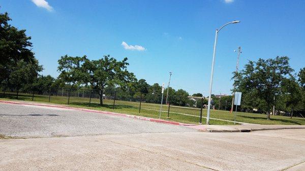 There is a fence devised school yard and the park