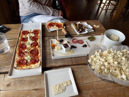 Pepperoni flatbread, charcuterie, olives, truffle popcorn