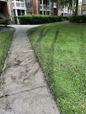 Moving vans, service vehicles allowed to drive across lawn. Vehicles tear up lawn, mud gets on sidewalk, tracked into apartments.