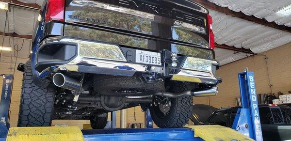 My Silverado up on the lift. Duel exhaust, rounded chrome tips. Sounds bitchin.