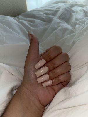 Acrylic nails painted in nude