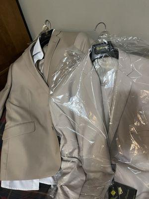 Fiancé suit next to the lighter groomsmen suit