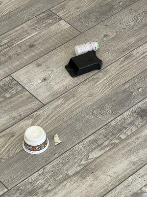 Yogurt cups and trash under couch