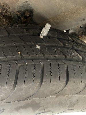 Another angle of metal piece stuck in tire