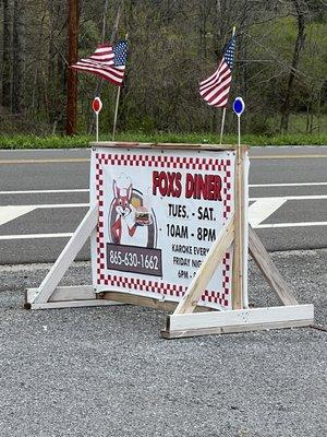 The sign out front by the side of the road