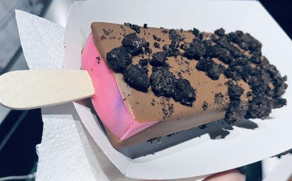 Bubble gum dipped in milk chocolate with Oreo crumbles