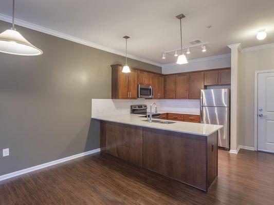 Full kitchen with granite counter tops and stainless steel appliances.