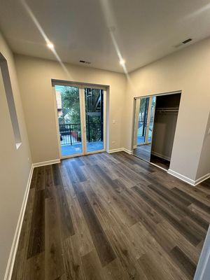 Second bedroom with plenty of sunlight, generous closet space, and direct access to a porch.