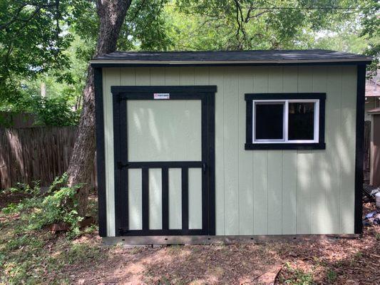 10x12 Premier Tall Ranch with 3x2 window and door with wainscoat door drim on side wall.