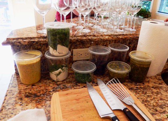 Chef Chris Brogan's organized, prepped sauces, herbs with his knives and utensils.