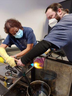 Using the burner to heat up the end of glass