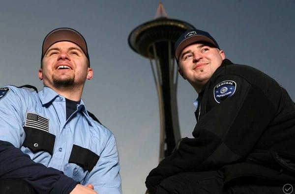 Security guards in Seattle with the Space Needle in the background.