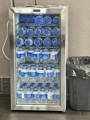 Fridge stocked with complimentary water