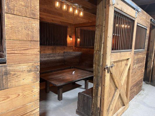 Private tables for reservation in converted horse stalls