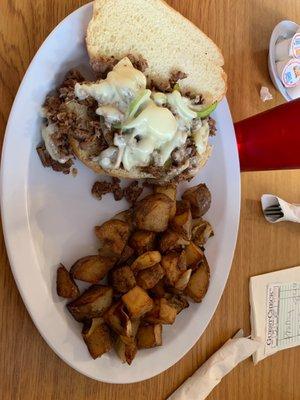 Philly cheesesteak and fried potatoes and onions