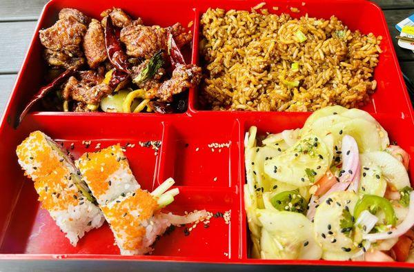 Bento box lunch - pickled cucumber salad, fried rice, sushi, beef