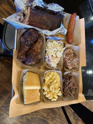 Bbq sampler: pulled pork, brisket, andouille sausage, smoked chicken legs, and ribs!! MacNcheese, coleslaw and cornbread on the side!