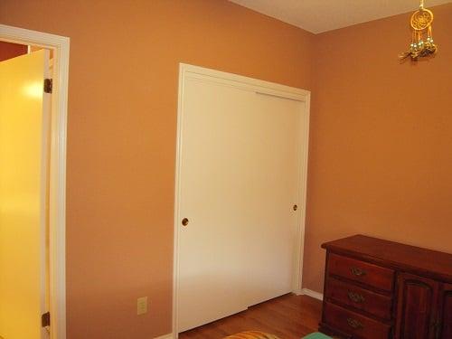 Multiple colors and lighting all play a role here in creating a warm and personal space in this bedroom.