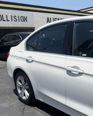 After: The BMW's new door is seamlessly installed and painted, with the quarter panel restored to a flawless, dent-free finish.