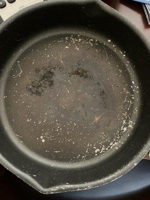 Very worn cooking pan in the kitchen.