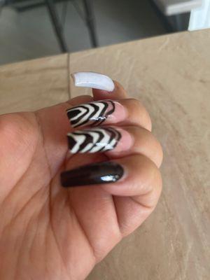 Weird nail shape, white turned to purple and terrible nail art.