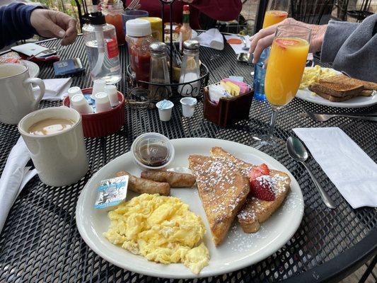 French toast, eggs, sausage, coffee, mimosa on the patio