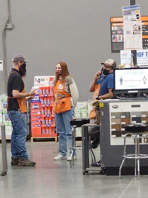 Home Depot Employee Jeff (blue shirt and Cap) to busy gossiping to help Customers.