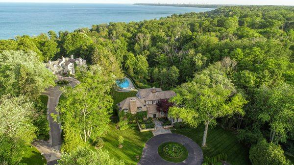 Aerial drone photo showcasing the lake in the background of the property