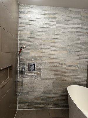 Cut off the existing tiles and change the shower body, find matching tiles, and replace them.