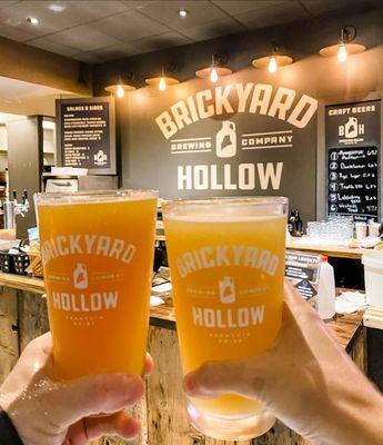 Couple cheers'ing their Craft beer at Brickyard Hollow brewpub in Portland Maine