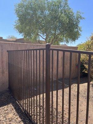 5' wrought iron fence with snake fencing. Color is "Rust", although it looks bronze to me!