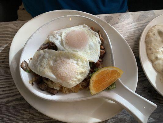 Breakfast skillet w hash browns, onions and mushrooms topped w 2 eggs