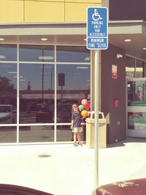 My granddaughter in front of the new store woohoo