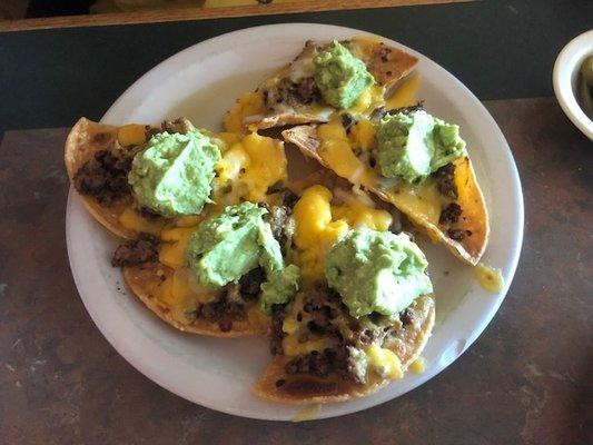 Loaded nachos with much more guacamole than expected.