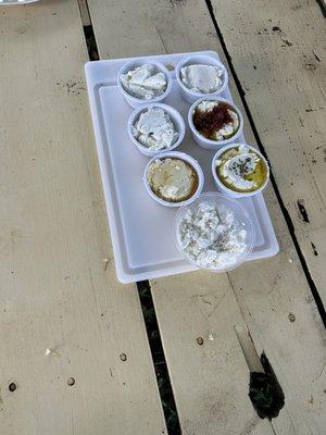 Variety of goat cheese samples served with crackers and fresh made pesto.