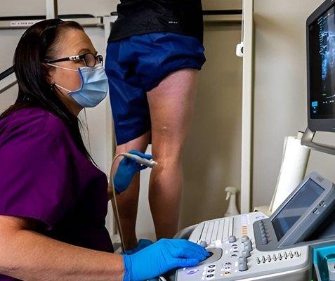 USA Vein Clinic Doctor looking at patient legs