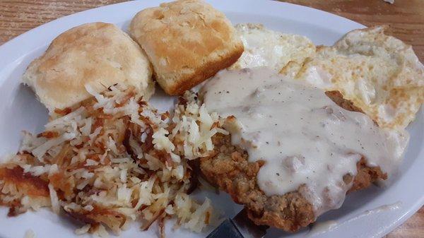 Chicken fried steak with fried eggs, biscuits and hash browns.  No flavor.