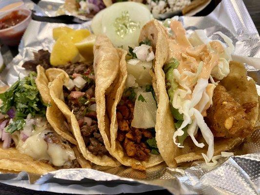 Left to right: birria, steak chimichurri, Al pastor, fish.